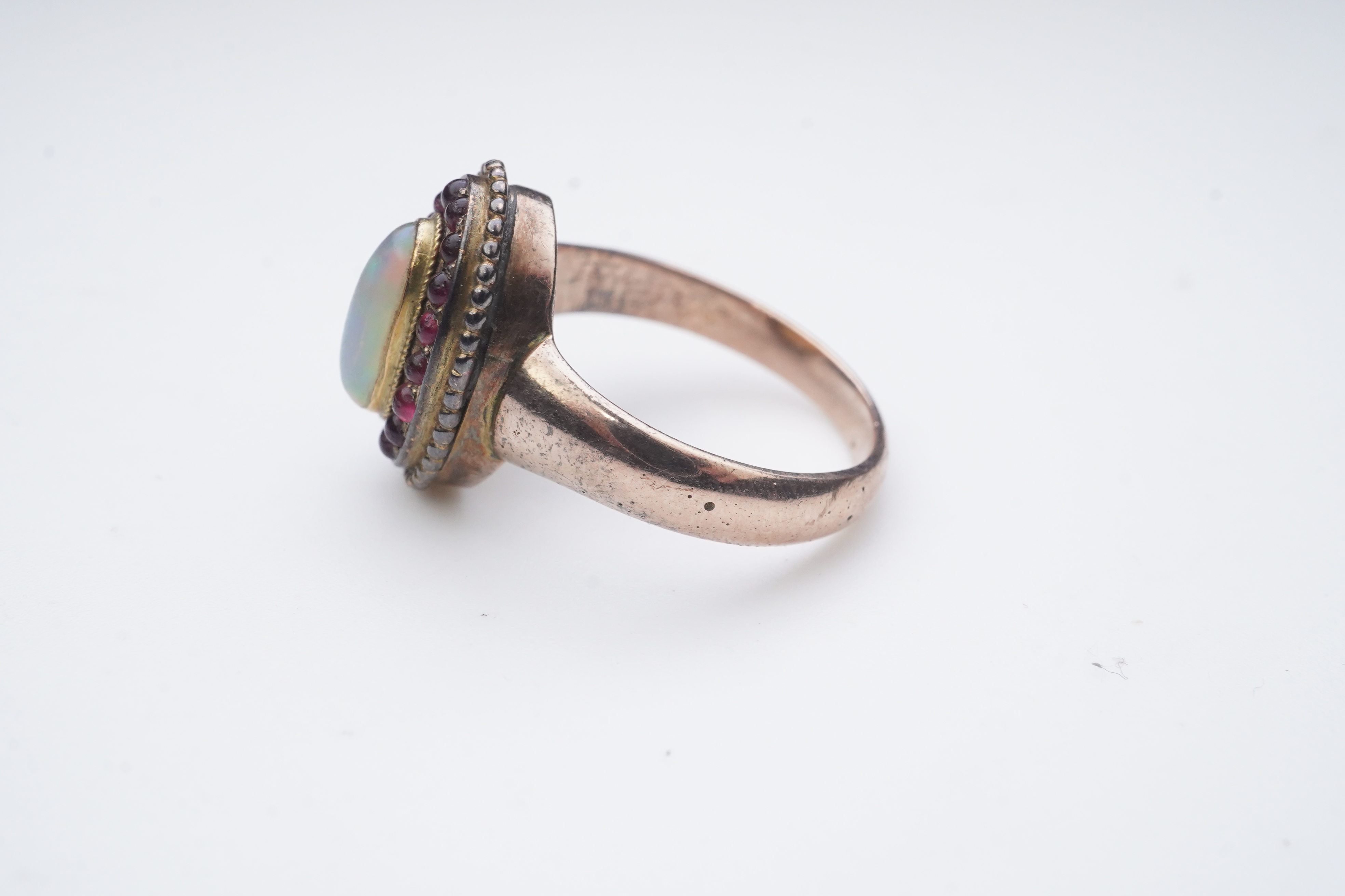 An opal and garnet ring